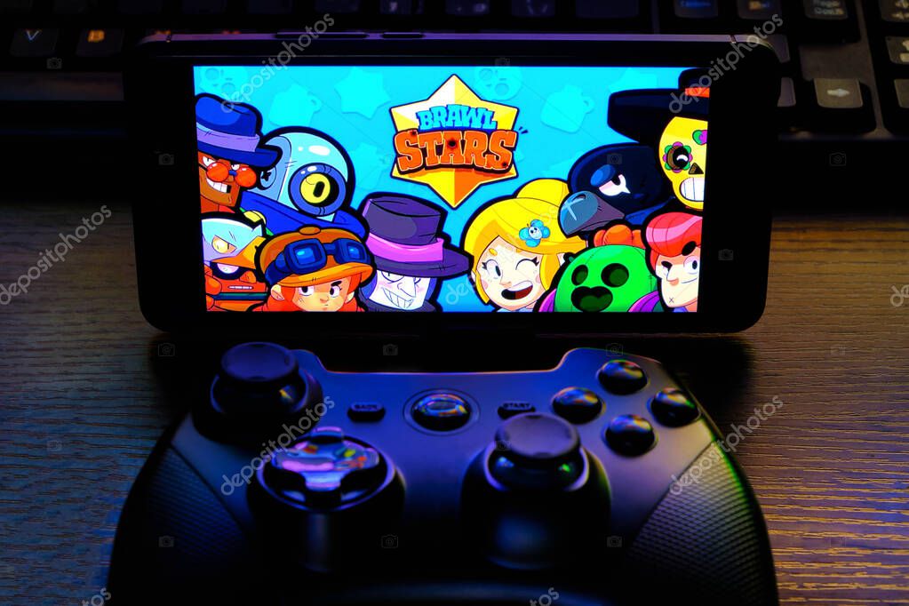 Kostanay, Kazakhstan, February 12, 2020.Joystick and mobile phone with the logo of the popular game Brawl Stars, from Supercell