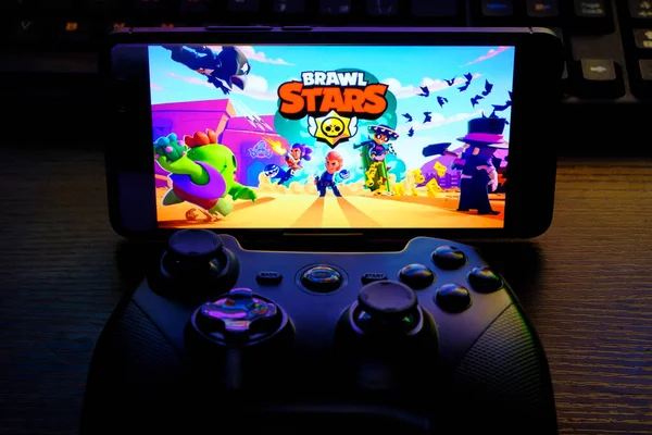 Kostanay, Kazakhstan, February 12, 2020.Joystick and mobile phone with the logo of the popular game Brawl Stars, from Supercell.
