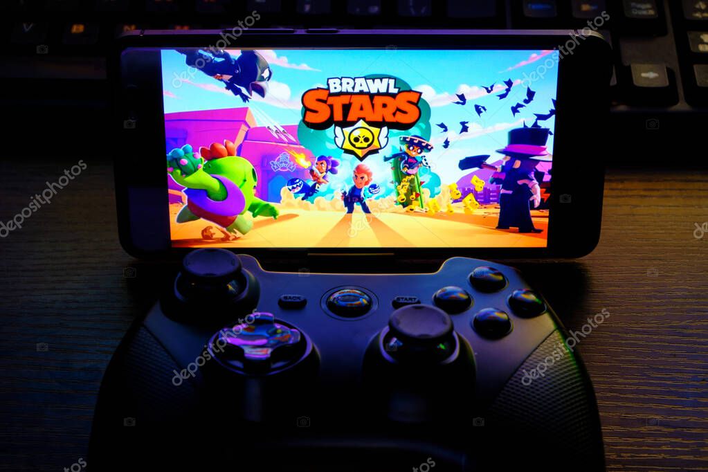 Kostanay, Kazakhstan, February 12, 2020.Joystick and mobile phone with the logo of the popular game Brawl Stars, from Supercell
