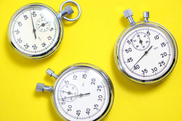 Three Mechanical Stopwatches Yellow Background — Stock Photo, Image