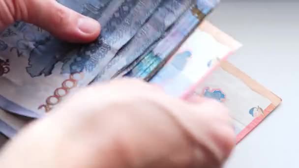 Man recalculates banknotes of Republic of Kazakhstan tenge, five, ten twenty thousand denominations. — Stock Video