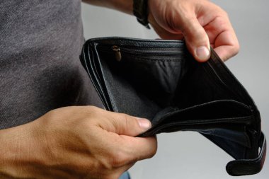 Adam parasız boş bir çantaya bakıyor. Para krizi yok.