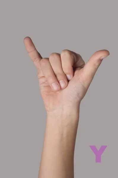 Alfabeto simbólico. Letra Y hecha por dedos sobre fondo gris — Foto de Stock