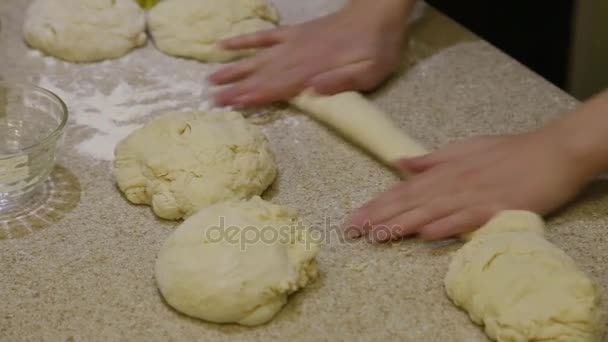 Cooking. Woman rolling dough on table — Stock Video