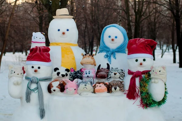 冬天有四个穿着衣服的雪人和雪兽呆在外面 — 图库照片