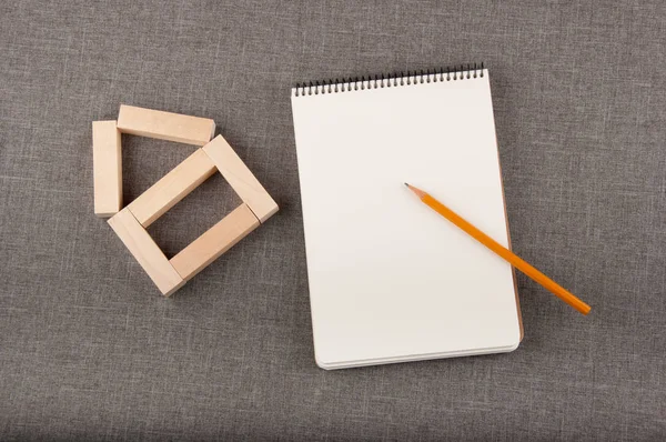 House Figure Made Small Wooden Blocks White Notepad Yellow Pencil — Stock Photo, Image