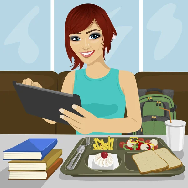 Studentka pomocí tabletu sedí ve fast food restaurace — Stockový vektor