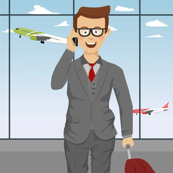 Successful cute businessman with glasses and suitcase talking on the phone at airport — Stock Vector