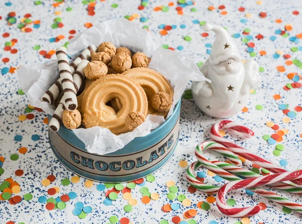 Christmas cookies gift box. Cookies, candies and christmas ornament Santa Claus on a light background