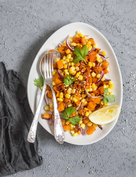 Pumpkin and corn salad with lemon dressing and cilantro. Top view
