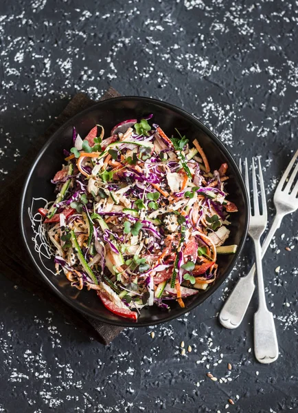 Red cabbage coleslaw with poached chicken. Healthy food concept. Salad with red cabbage, carrot, pepper, radish and boiled chicken, on a dark background, top view — Stock Image Red cabbage coleslaw with poached chicken. Healthy food concept. Salad with red cabbage, carrot, pepper, radish and boiled chicken, on a dark background, top view Royalty Free Stock Images