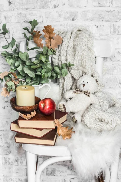 Home cozy still life - an old vintage chair, stack of books, knitted plaid, candle, apple fruit, teddy bear. Hobby, leisure, comfort concept. Flat lay — Stock Image Home Cozy Still Life Old Vintage Chair Stack Books Knitted Stock Picture
