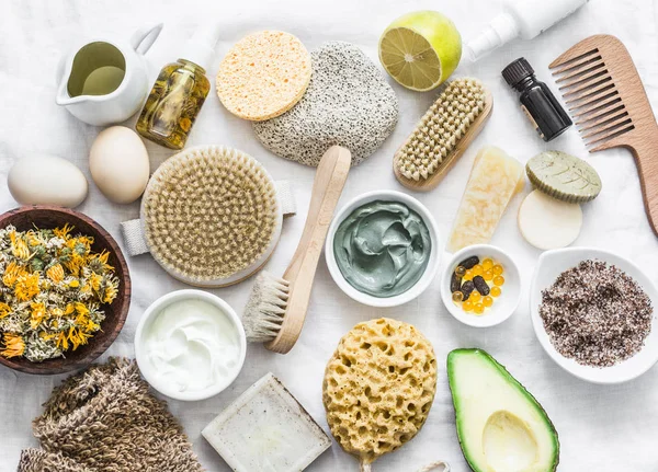 Face, body skin care homemade ingredients - cosmetic clay, brushes, homemade soap, coffee scrub, avocado, lemon, homemade oatmeal soap, calendula, chamomile dried flowers, natural yogurt on a white background, top view. Beauty, healthy lifestyle conc — Stock Image Face Body Skin Care Homemade Ingredients Cosmetic Clay Brushes Homemade Stock Photo