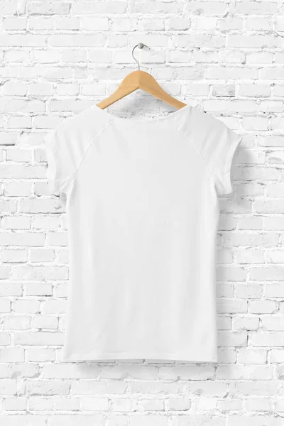 Blank White Women\'s T-Shirt Mock-up on wooden hanger, rear side view. 3D Rendering.