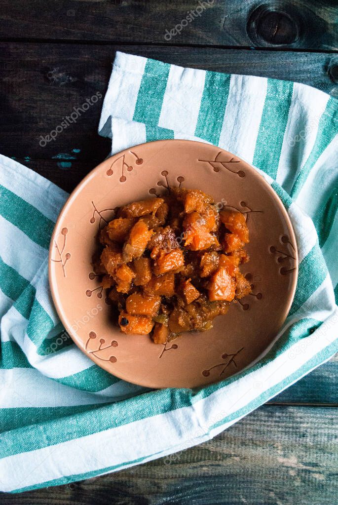 Stewed curry pumpkin in a ceramic bowl