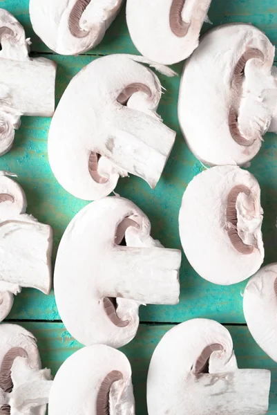 Sliced raw white champignons preparing for cooking