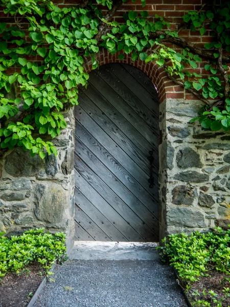 Wooden door on brick and stone building Stock Picture