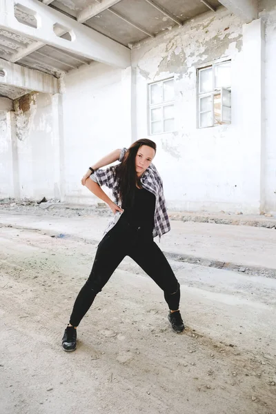 Girl dancing hip-hop in old industrial building. Young girl art dance. Street urban lifestyle.