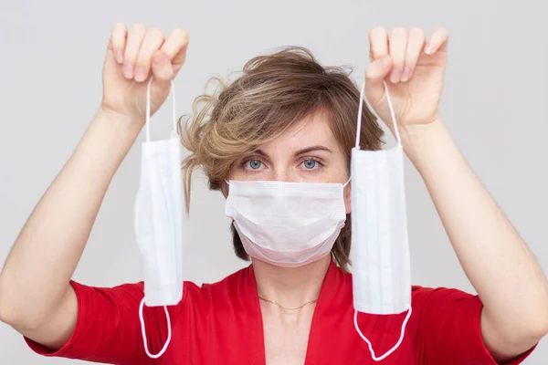 Cute girl wearing a health mask, looking straight, isolated on a white background, flu Epidemic, dust Allergy, virus protection. Concept of air pollution in the city, close-up