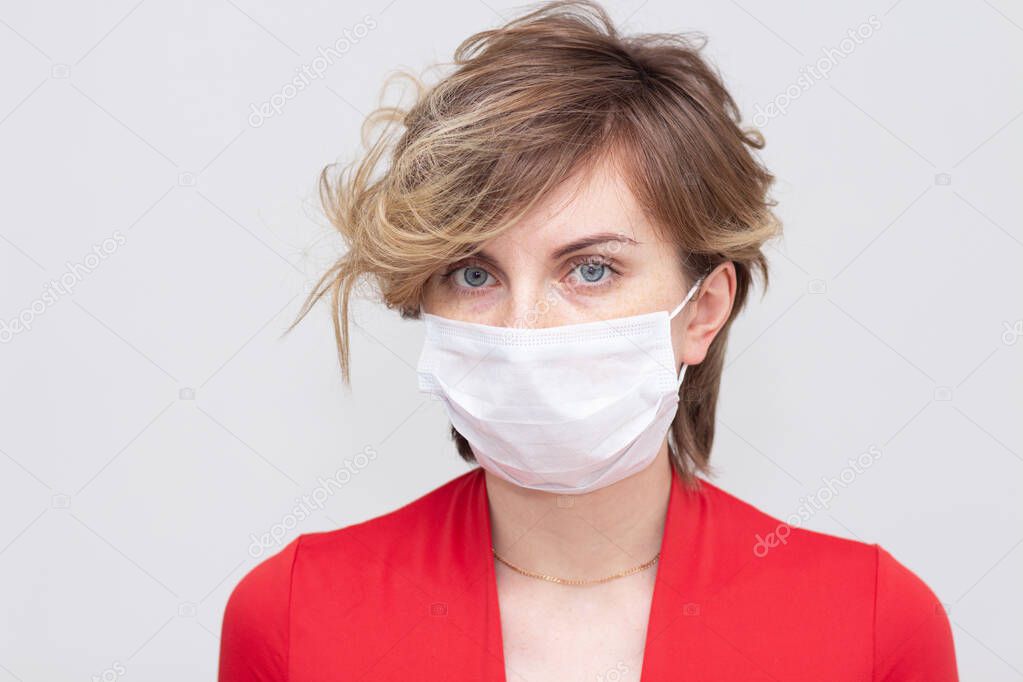 Cute girl wearing a health mask, looking straight, isolated on a white background, flu Epidemic, dust Allergy, virus protection. Concept of air pollution in the city, close-up