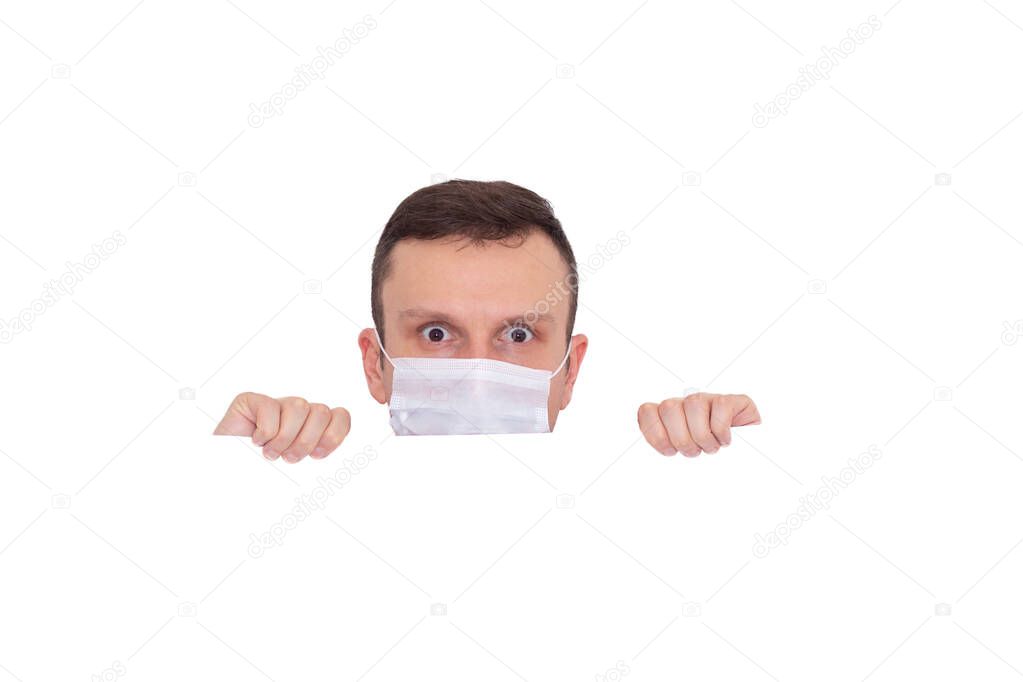 Portrait of a man on a white isolated background, face covered with a medical mask, banner for text. Health, awareness, and timeliness. Healthy lifestyle. No viruses.