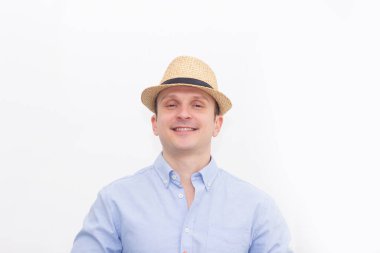Şapkalı mutlu bir gencin fotoğrafı. Arka planda tek başına duruyor. Kapatın. Parlak duygu.