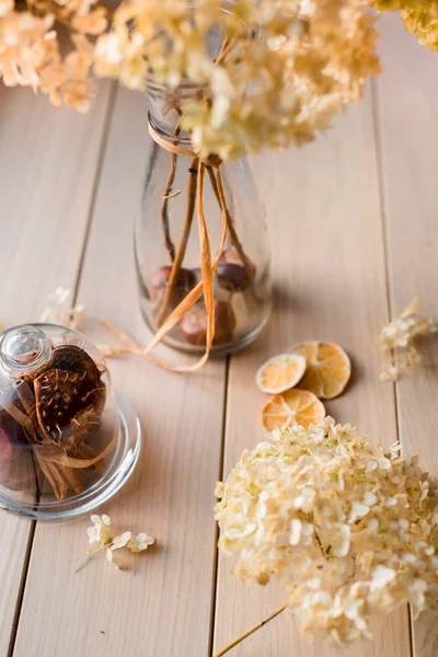 Autumn still life, dry hydrangea and lemon on a wooden background — Stock Photo, Image