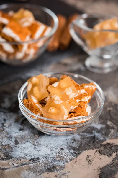 Spring summer dessert in a glass cup on a dark gray background. Oriental sweets, nuts, nougat, cake, puff cake — Stock Photo, Image