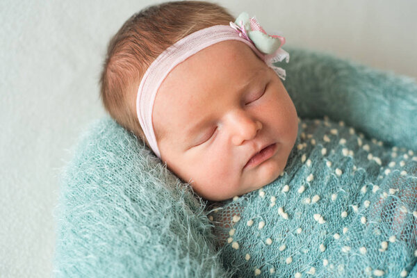 Lovely newborn girl in dress sleeping