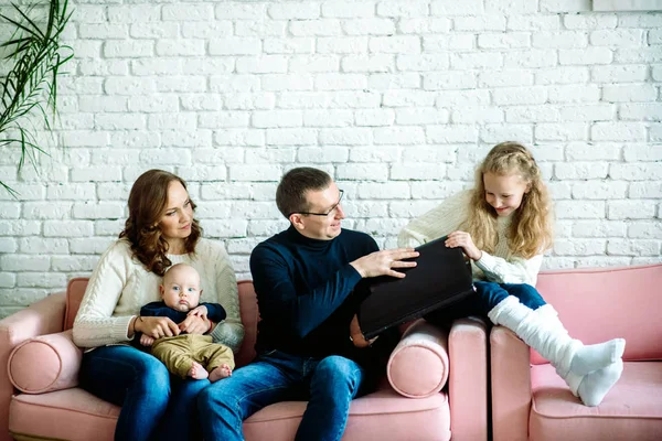 Generations Misunderstanding. Irritated Dad Yelling At Offended Son Working On Laptop Sitting On Sofa Indoor. Selective Focus