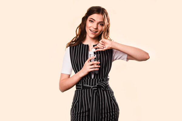 Woman suffering head ache holding a water glass. Migraine and fever, pain relievers. Girl in the studio on a light background. medical care concept.