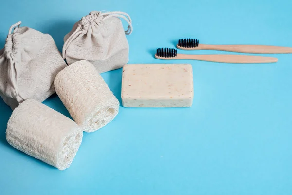 Residuos cero hogar, producto ecológico cosmético sobre un fondo azul. cepillo de bambú, esponja vegetal, toalla de algodón. Flat lay Copiar espacio . — Foto de Stock