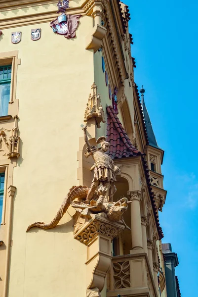 Sculpture of Saint George and dragon on the facade of the building. Prague, Czech