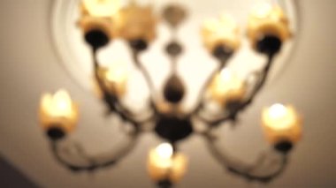 Footage of old fashion vintage chandelier. Camera turns around, low angle