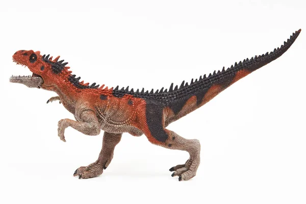 Saurophaganax dinosaur rubber toy isolated on white — Stock Photo, Image