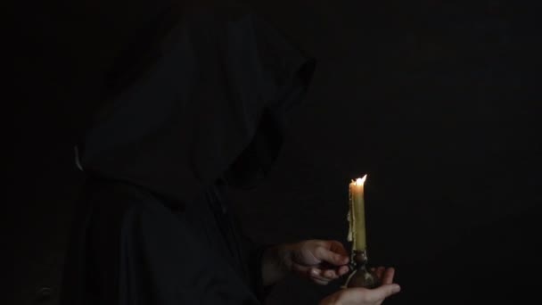 Bearded Monk Reads Prayer Candlelight Flame Candle Sways — Stock Video