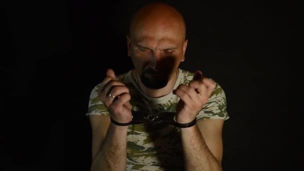 Military Man Sits Handcuffs Man Hands Shackles — Stock Video