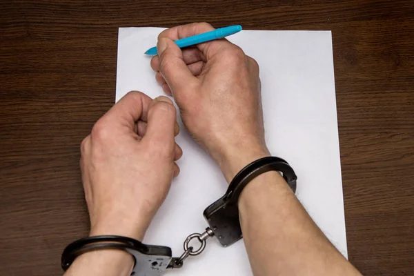Man Bare Hands Handcuffs Sits Table Front Blank Sheet Paper — 스톡 사진