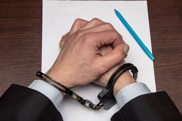 Man Bare Hands Handcuffs Sits Table Front Blank Sheet Paper — Stock Photo, Image