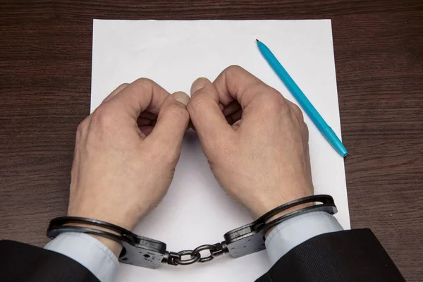 Man Bare Hands Handcuffs Sits Table Front Blank Sheet Paper — Stock Photo, Image