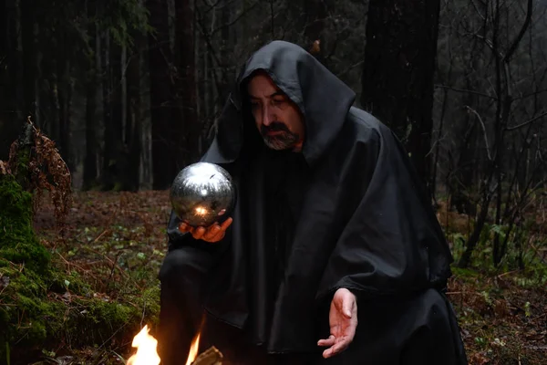 Black Robed Monk Sits Fire Forest Looks Divination Ball Mysticism — Stock Photo, Image