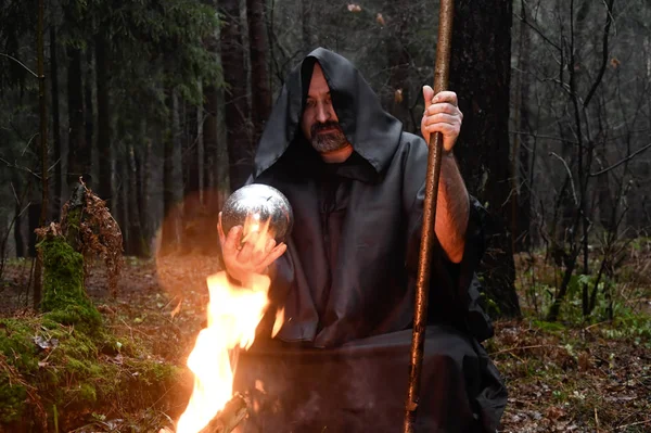 Black Robed Monk Sits Fire Forest Looks Divination Ball Mysticism — Stock Photo, Image