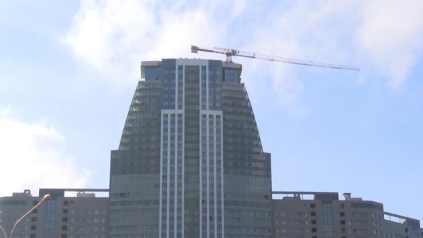 Hochhausbau Der Turmdrehkran Baut Einen Wolkenkratzer Auf Einem Hintergrund Aus — Stockvideo