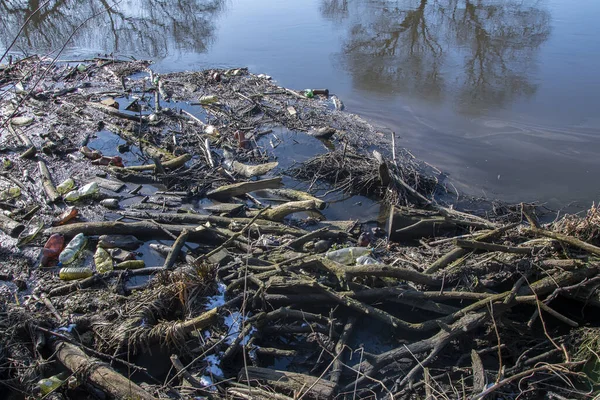 Dam of sticks and debris floating on the river, environmental pollution,