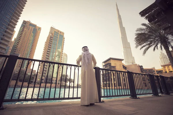 Homem árabe assistindo Dubai skyline noite hora — Fotografia de Stock