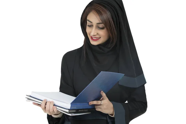 Studente arabo che indossa abaya, tenendo libro blu — Foto Stock