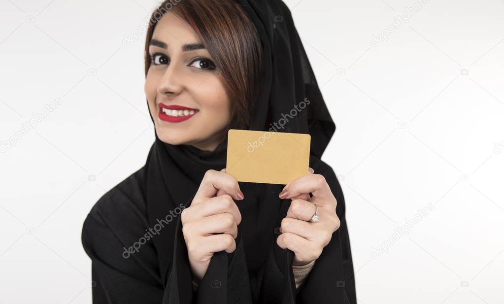 Arab woman holding credit card. Isolated portrait of smiling bus