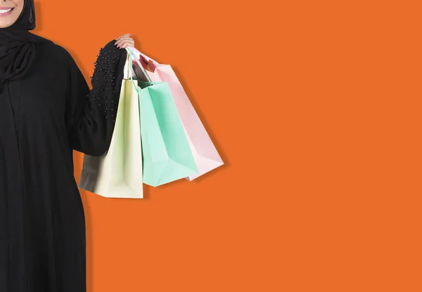 Arab woman holding shopping bags