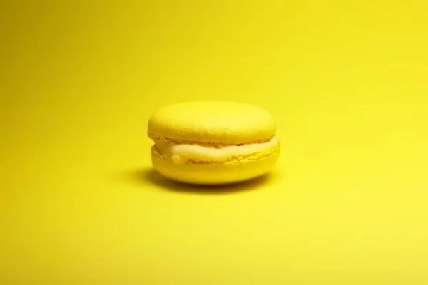 Yellow macaroon cake on yellow background bright food photography
