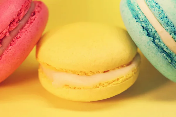 Bright food photography of macroons on yellow background